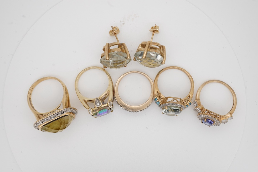 Five modern assorted 9ct gold and gem set rings, including diamond cluster half hoop and a pair of modern 9ct gold and gem set earrings, gross 38.4 grams. Condition - fair to good